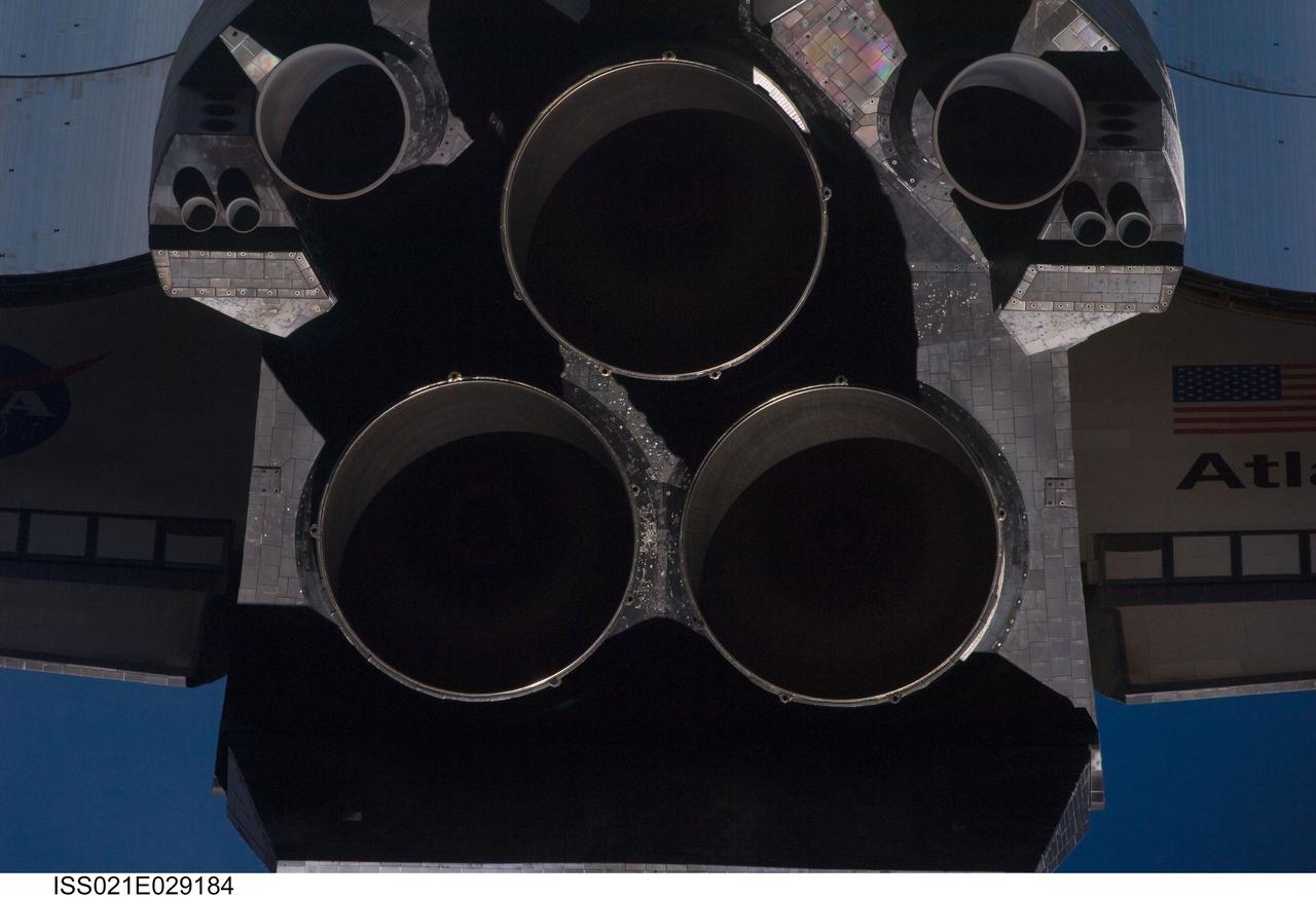 ISS021-E-029184 (18 Nov. 2009) --- This view of the aft portion of the Space Shuttle Atlantis, including the three main engines, was provided by an Expedition 21 crew member during a survey of the approaching vehicle prior to docking with the International Space Station. As part of the survey and part of every mission's activities, Atlantis performed a back-flip for the rendezvous pitch maneuver (RPM). The image was photographed with a digital still camera, using a 400mm lens at a distance of about 600 feet (180 meters).