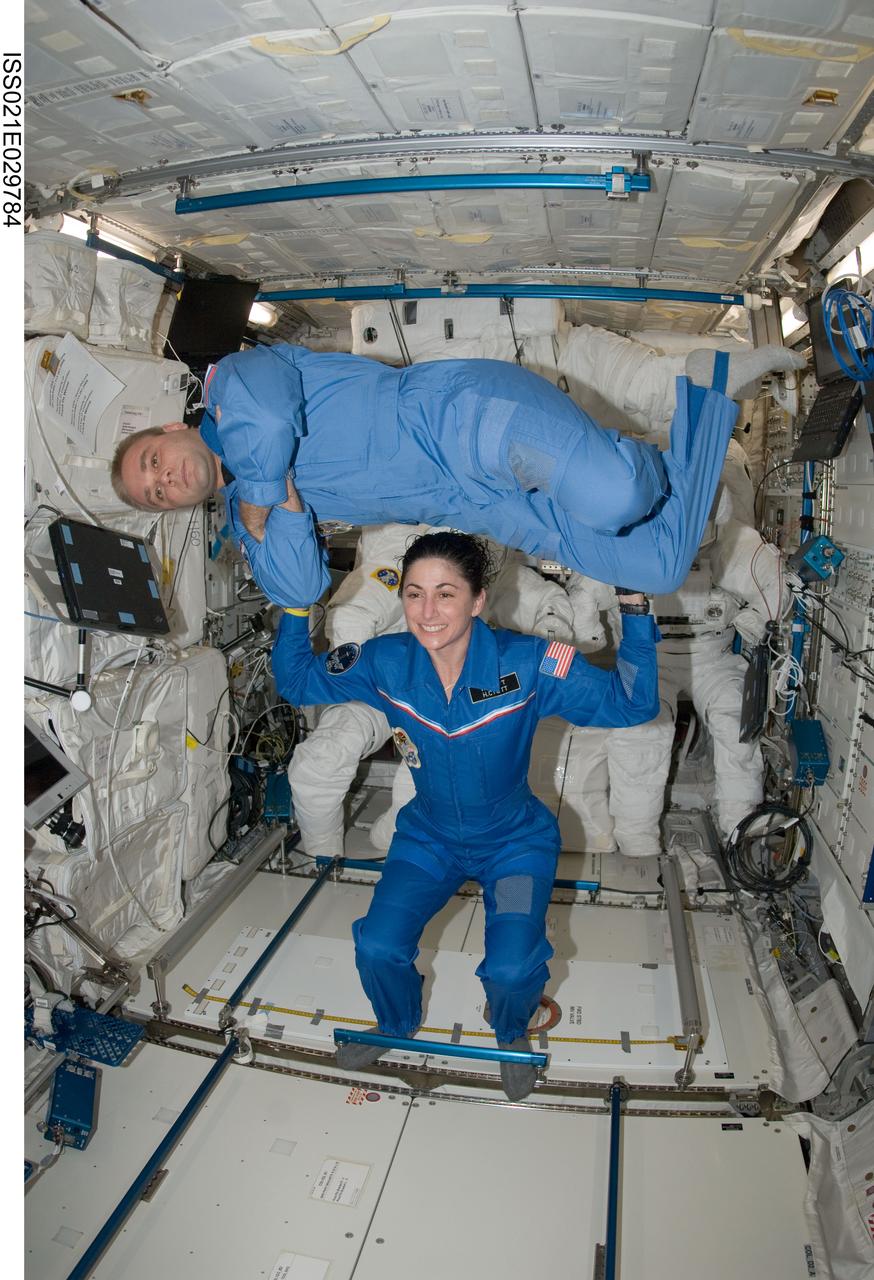 ISS021-E-029784 (17 Nov. 2009) --- NASA astronaut Nicole Stott and Russian cosmonaut Maxim Suraev, both Expedition 21 flight engineers, pose for a photo in the Columbus laboratory of the International Space Station.