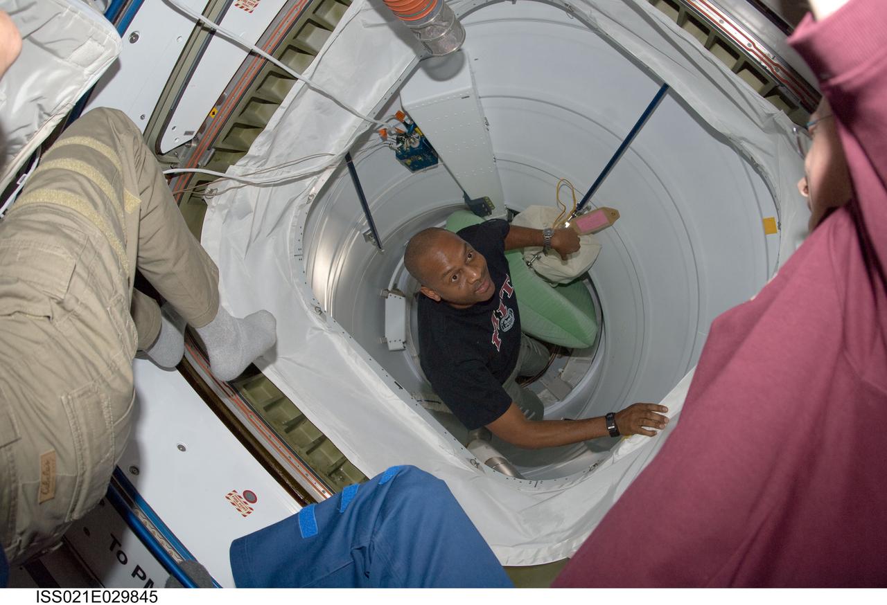 ISS021-E-029845 (18 Nov. 2009) --- Astronaut Robert L. Satcher Jr., STS-129 mission specialist, enters the International Space Station shortly after Space Shuttle Atlantis and the International Space Station docked in space and the hatches were opened on Nov. 18, 2009.