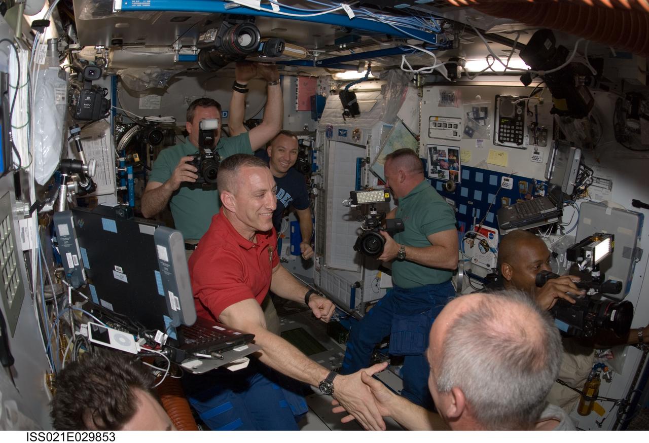 ISS021-E-029853 (18 Nov. 2009) --- STS-129 and Expedition 21 crew members are pictured shortly after Space Shuttle Atlantis and the International Space Station docked in space and the hatches were opened on Nov. 18, 2009. Pictured are NASA astronauts Charles O. Hobaugh (left foreground), STS-129 commander; Jeffrey Williams (right foreground), Expedition 21 flight engineer; Barry E. Wilmore (right, with camera), STS-129 pilot; Mike Foreman (left background) and Randy Bresnik, both STS-129 mission specialists.