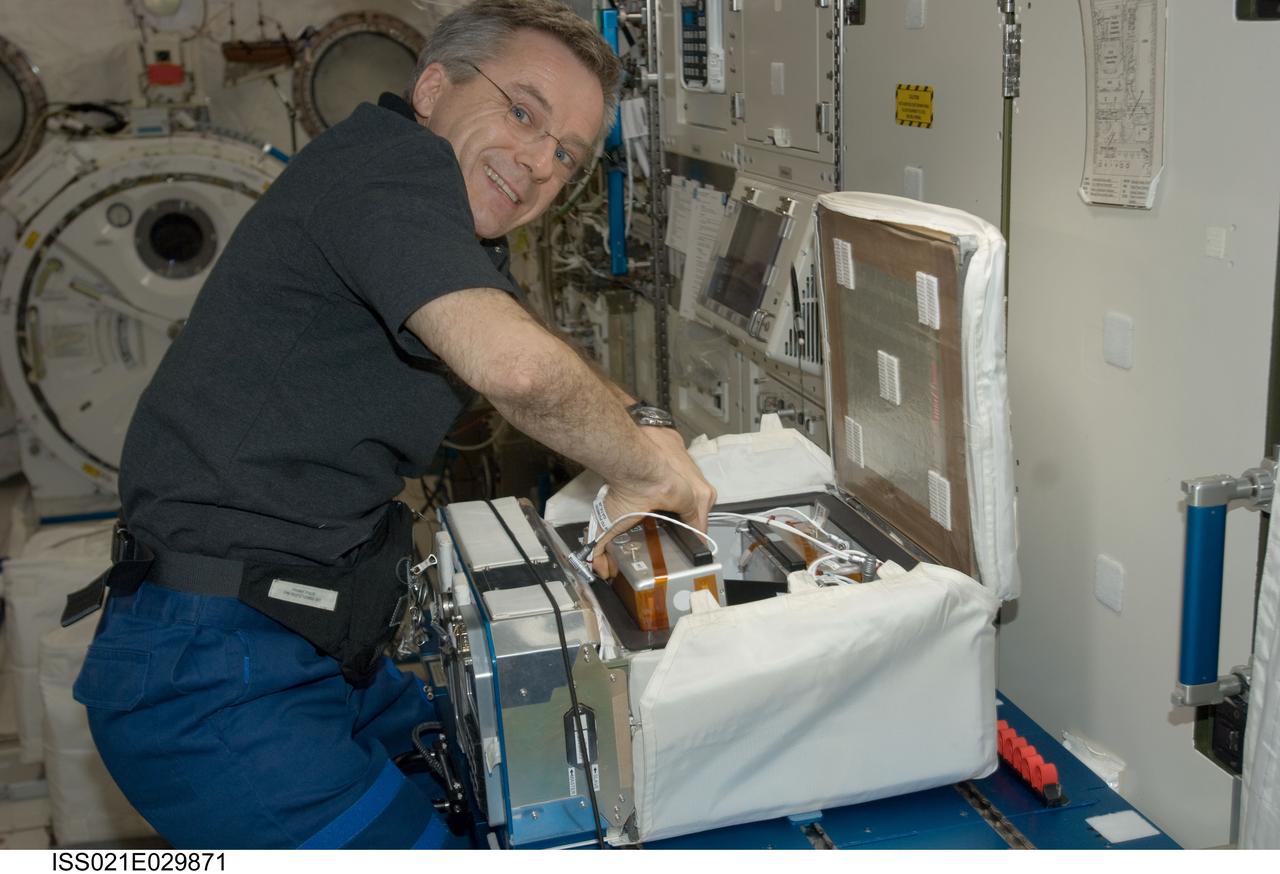 ISS021-E-029871 (18 Nov. 2009) --- Canadian Space Agency astronaut Robert Thirsk, Expedition 21 flight engineer, works with the new Commercial Generic Bioprocessing Apparatus (CGBA) Science Insert 03 (CSI-03) assembly in the Kibo laboratory of the International Space Station. CSI-03 is flying two butterfly habitats during this mission and will examine the complete life cycle of the butterflies as they eat, grow and undergo metamorphosis in space.