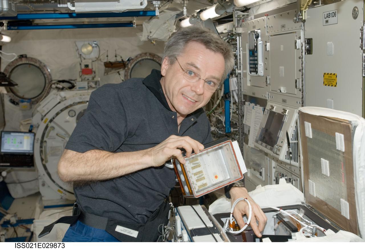 ISS021-E-029873 (18 Nov. 2009) --- Canadian Space Agency astronaut Robert Thirsk, Expedition 21 flight engineer, works with the new Commercial Generic Bioprocessing Apparatus (CGBA) Science Insert 03 (CSI-03) assembly in the Kibo laboratory of the International Space Station. CSI-03 is flying two butterfly habitats during this mission and will examine the complete life cycle of the butterflies as they eat, grow and undergo metamorphosis in space.