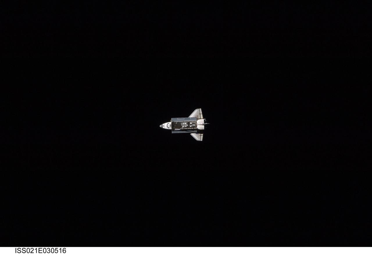 ISS021-E-030516 (18 Nov. 2009) --- Surrounded by the blackness of space, the Space Shuttle Atlantis appears very small from the point of view of the International Space Station as the shuttle approaches the station during STS-129 rendezvous and docking operations. Docking occurred at 10:51 a.m. (CST) on Nov. 18, 2009.