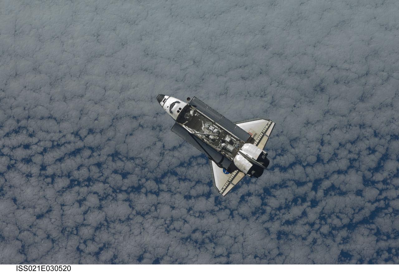 ISS021-E-030520 (18 Nov. 2009) --- Backdropped by a blue and white part of Earth, Space Shuttle Atlantis is featured in this image photographed by an Expedition 21 crew member as the shuttle approaches the International Space Station during STS-129 rendezvous and docking operations. Docking occurred at 10:51 a.m. (CST) on Nov. 18, 2009.
