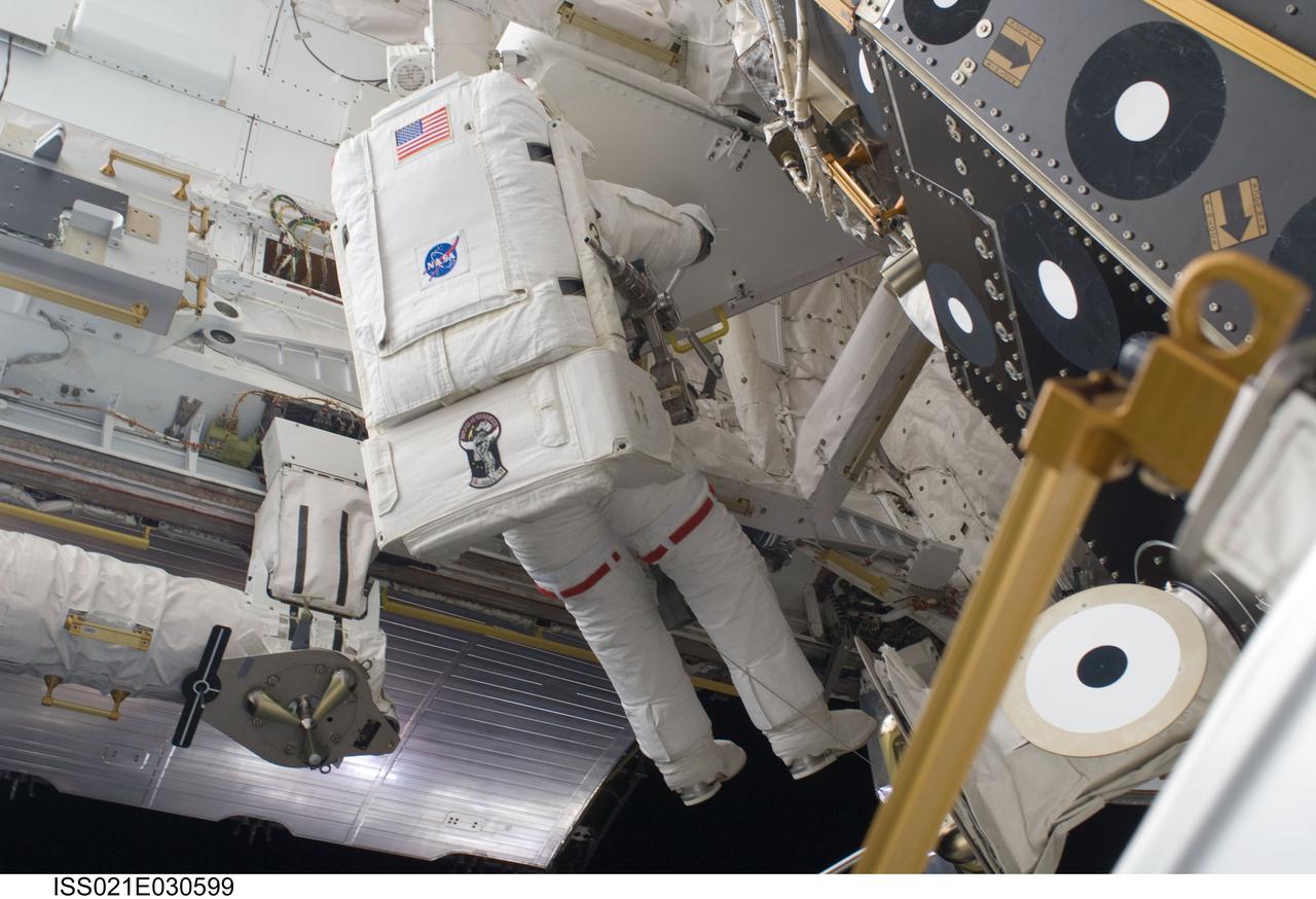 ISS021-E-030599 (21 Nov. 2009) --- Astronaut Randy Bresnik, STS-129 mission specialist, performs a task on the exterior of the International Space Station during the second spacewalk of the Atlantis’ visit to the orbital outpost.