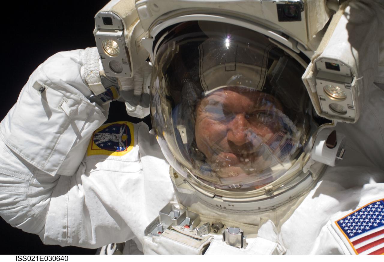 ISS021-E-030640 (21 Nov. 2009) --- Astronaut Mike Foreman, STS-129 mission specialist, looks toward his camera bearing crewmate, astronaut Randy Bresnik, who captured the image with an electronic still camera. The two were in the midst of the second scheduled  spacewalk for the Atlantis crew members.