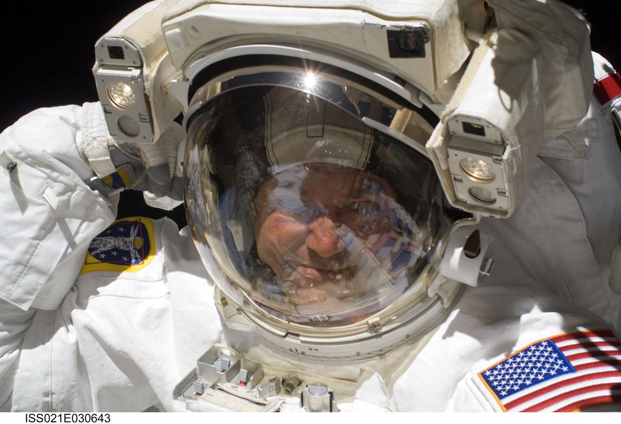 ISS021-E-030643 (21 Nov. 2009) --- Astronaut Mike Foreman, STS-129 mission specialist, looks toward his camera bearing crewmate, astronaut Randy Bresnik, who captured the image with an electronic still camera. The two were in the midst of the second scheduled  spacewalk for the Atlantis crew members.