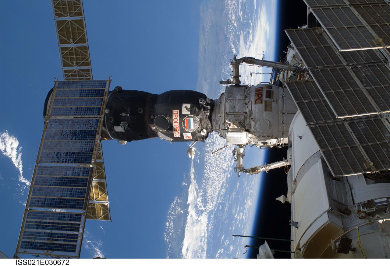 ISS021-E-030672 (21 Nov. 2009) --- Russia’s Progress 35P is docked to the Pirs Docking Compartment, photographed during the middle of three scheduled sessions of extravehicular activity (EVA) shared by the Atlantis STS-129 crew and the five crew members of Expedition 21.