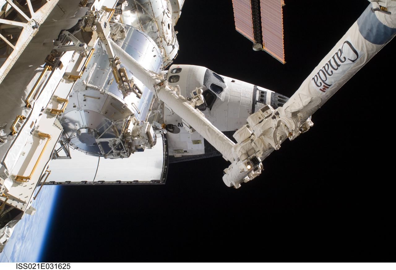 ISS021-E-031625 (23 Nov. 2009) --- A partial view of the space shuttle Atlantis (STS-129), docked to the International Space Station, along with the station’s Canadarm2, the Columbus laboratory and Harmony node are featured in this image photographed by a space-walking astronaut during the mission’s third and final spacewalk.