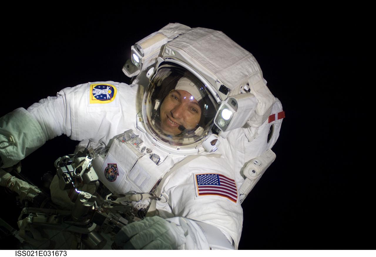 ISS021-E-031673 (23 Nov. 2009) --- Astronaut Randy Bresnik, STS-129 mission specialist, participates in the mission's third and final session of extravehicular activity (EVA) as construction and maintenance continue on the International Space Station. During the five-hour, 42-minute spacewalk, Bresnik and Robert L. Satcher Jr. (out of frame), mission specialist, removed a pair of micrometeoroid and orbital debris shields from the Quest airlock and strapped them to the External Stowage Platform #2, then moved an articulating foot restraint to the airlock, and released a bolt on a starboard truss ammonia tank assembly (ATA) in preparation for an STS-131 spacewalk that will replace the ATA.