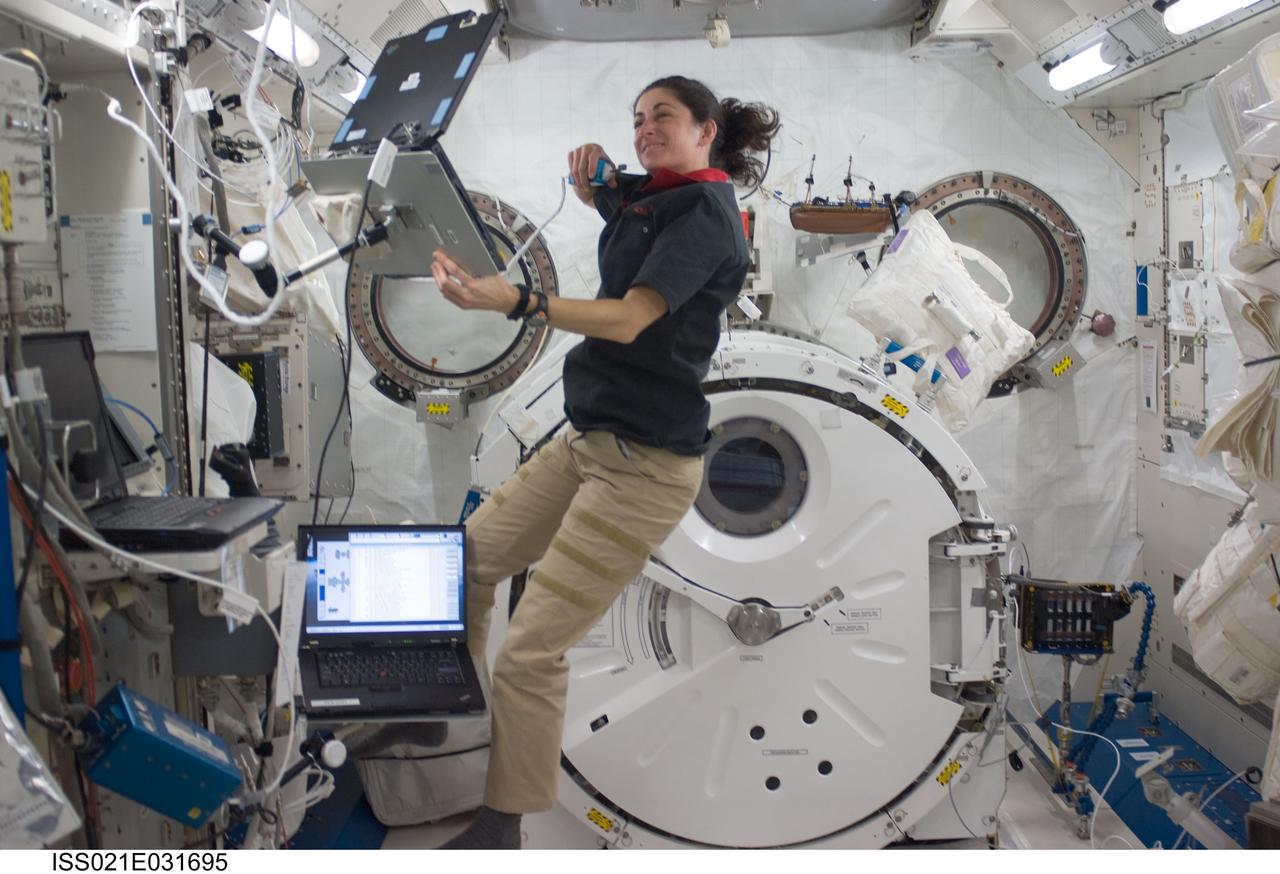 ISS021-E-031695 (22 Nov. 2009) --- Astronaut Nicole Stott, STS-129 mission specialist, uses a communication system near a computer in the Kibo laboratory of the International Space Station while space shuttle Atlantis remains docked with the station.