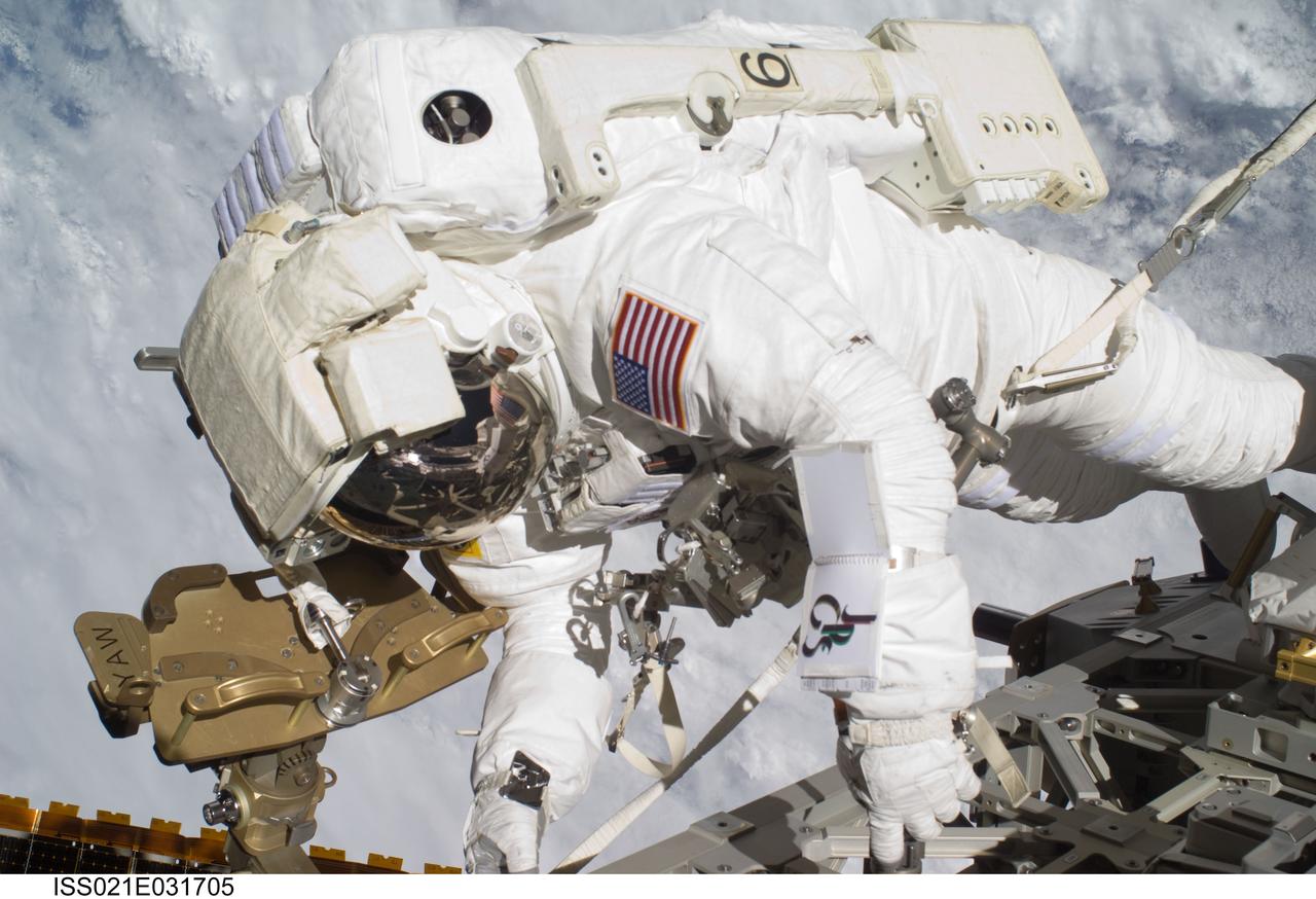 ISS021-E-031705 (23 Nov. 2009) --- Astronaut Robert L. Satcher Jr., STS-129 mission specialist, participates in the mission's third and final session of extravehicular activity (EVA) as construction and maintenance continue on the International Space Station. During the five-hour, 42-minute spacewalk, Satcher and astronaut Randy Bresnik (out of frame), mission specialist, removed a pair of micrometeoroid and orbital debris shields from the Quest airlock and strapped them to the External Stowage Platform #2, then moved an articulating foot restraint to the airlock, and released a bolt on a starboard truss ammonia tank assembly (ATA) in preparation for an STS-131 spacewalk that will replace the ATA.