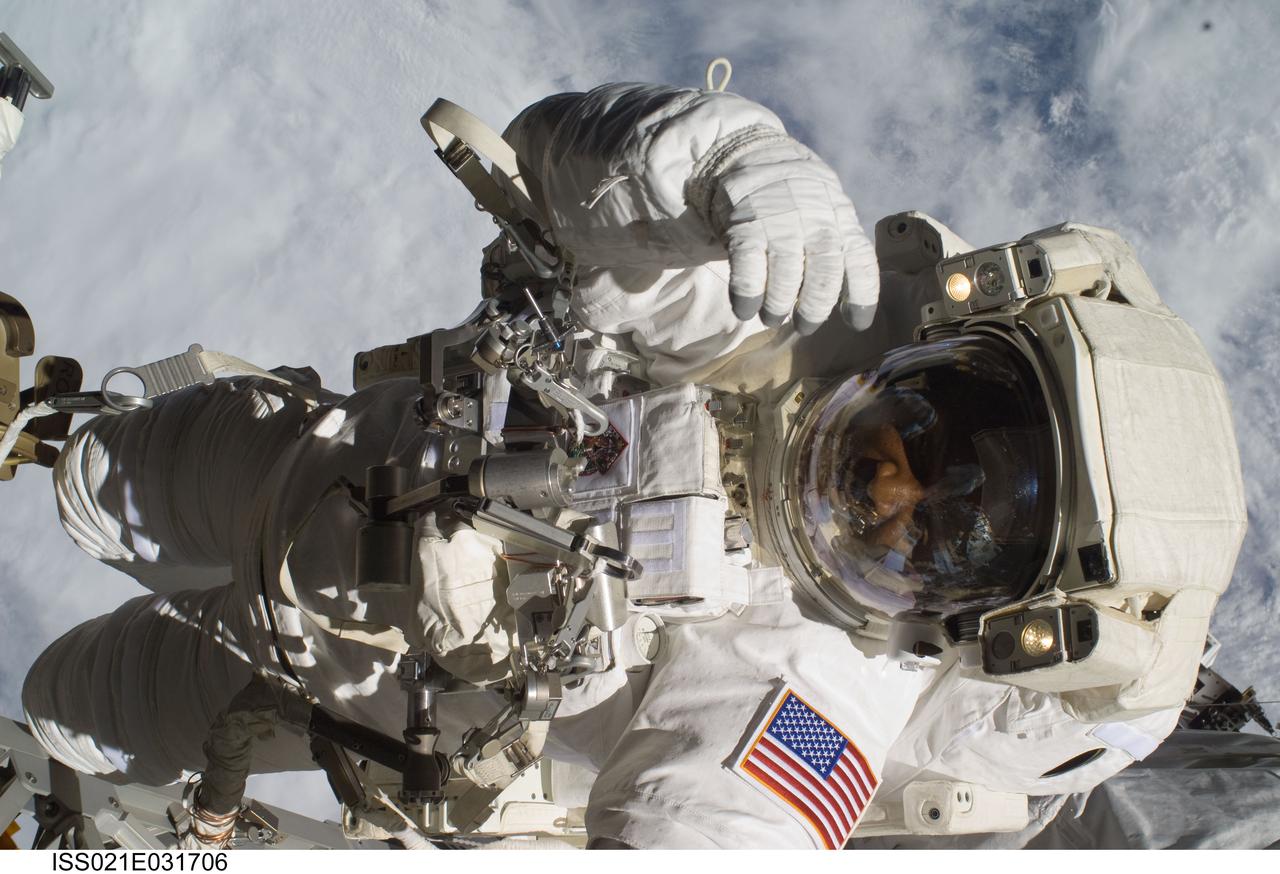 ISS021-E-031706 (23 Nov. 2009) --- Astronaut Robert L. Satcher Jr., STS-129 mission specialist, participates in the mission's third and final session of extravehicular activity (EVA) as construction and maintenance continue on the International Space Station. During the five-hour, 42-minute spacewalk, Satcher and astronaut Randy Bresnik (out of frame), mission specialist, removed a pair of micrometeoroid and orbital debris shields from the Quest airlock and strapped them to the External Stowage Platform #2, then moved an articulating foot restraint to the airlock, and released a bolt on a starboard truss ammonia tank assembly (ATA) in preparation for an STS-131 spacewalk that will replace the ATA.