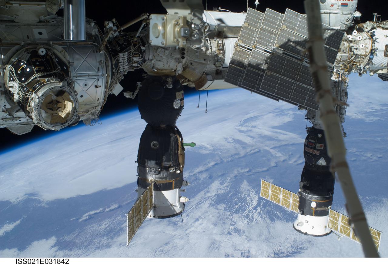 ISS021-E-031842 (23 Nov. 2009) --- A portion of the Russian segment of the International Space Station is featured in this image photographed by a space-walking astronaut during the third and final spacewalk for the STS-129 mission. A docked Soyuz spacecraft is at center and a Progress resupply vehicle is docked to the Pirs Docking Compartment. Earth’s horizon and the blackness of space provide the backdrop for the scene.