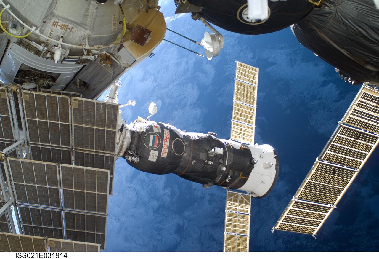 ISS021-E-031914 (23 Nov. 2009) --- A Russian Progress resupply vehicle docked to the International Space Station is featured in this image photographed by an Expedition 21 crew member while space shuttle Atlantis (STS-129) remains docked with the station. A blue part of Earth provides the backdrop for the scene.