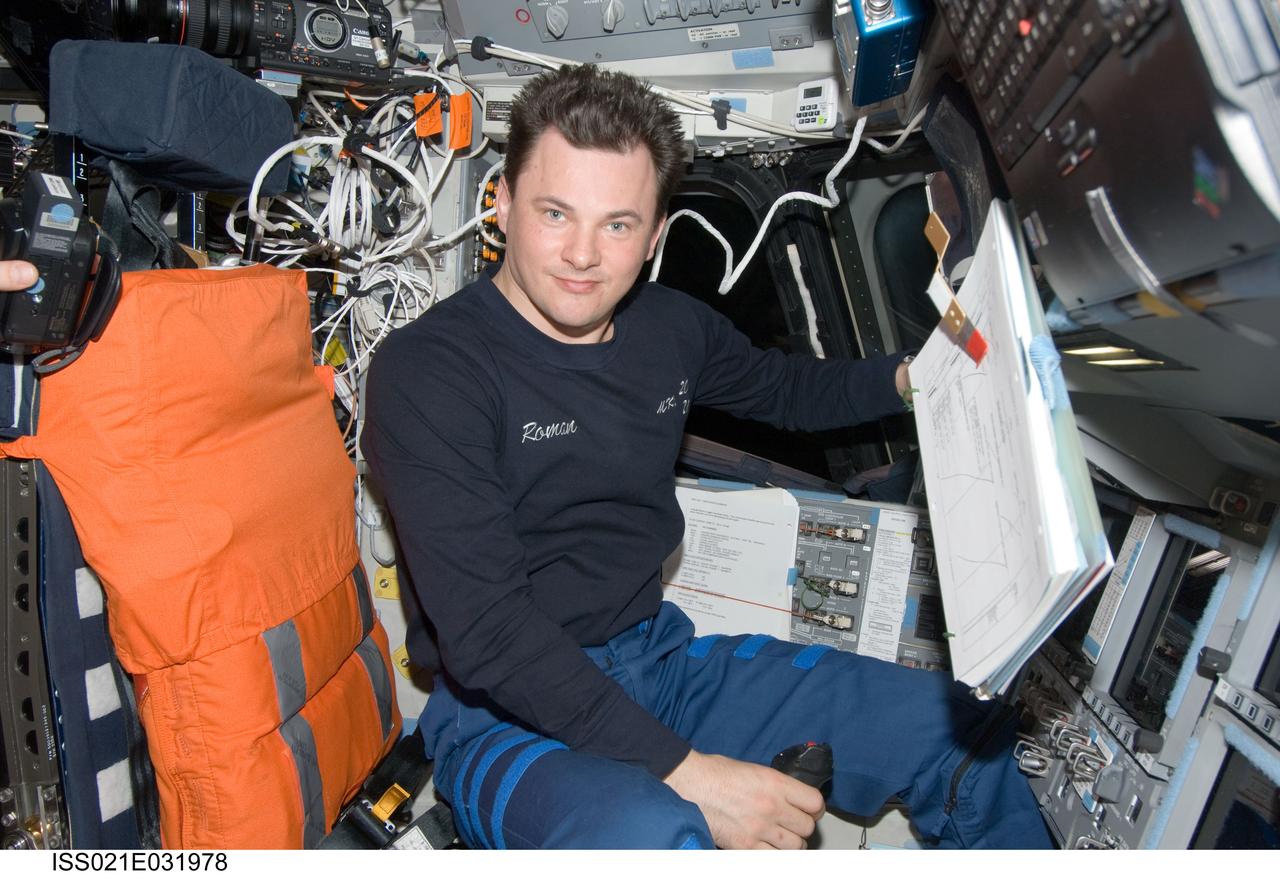 ISS021-E-031978 (23 Nov. 2009) --- Cosmonaut Roman Romanenko, Expedition 21 flight engineer, occupies the commander’s station on the flight deck of space shuttle Atlantis (STS-129) while docked with the International Space Station.