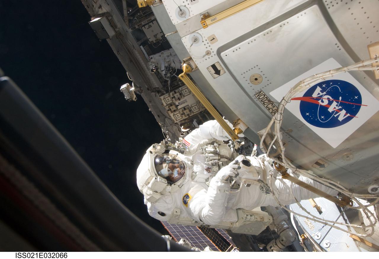 ISS021-E-032066 (23 Nov. 2009) --- Astronaut Robert L. Satcher Jr., STS-129 mission specialist, participates in the mission's third and final session of extravehicular activity (EVA) as construction and maintenance continue on the International Space Station. During the five-hour, 42-minute spacewalk, Satcher and astronaut Randy Bresnik (out of frame), mission specialist, removed a pair of micrometeoroid and orbital debris shields from the Quest airlock and strapped them to the External Stowage Platform #2, then moved an articulating foot restraint to the airlock, and released a bolt on a starboard truss ammonia tank assembly (ATA) in preparation for an STS-131 spacewalk that will replace the ATA.