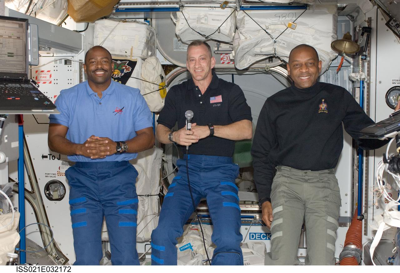 ISS021-E-032172 (20 Nov. 2009) --- NASA astronauts Charles O. Hobaugh (center), STS-129 commander; along with Leland Melvin (left) and Robert L. Satcher Jr., both mission specialists, are pictured in the Harmony node of the International Space Station while space shuttle Atlantis remains docked with the station.