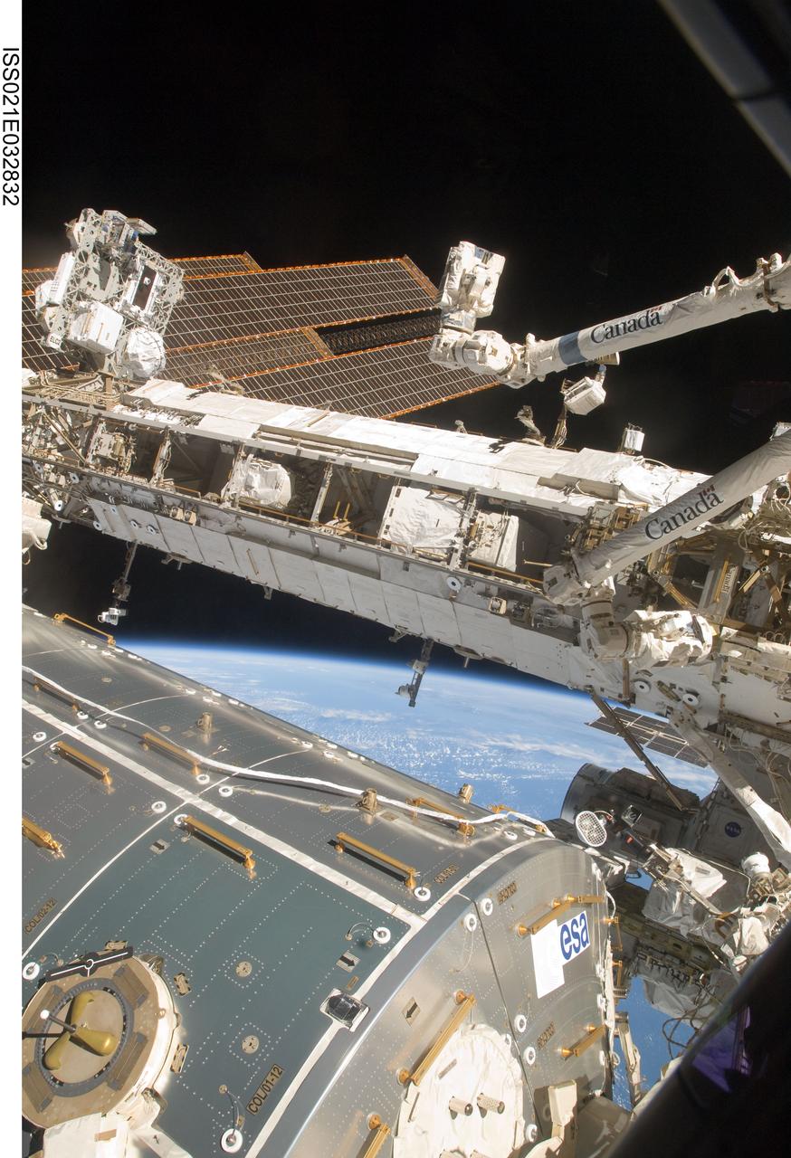 ISS021-E-032832 (24 Nov. 2009) --- Various segments of the International Space Station are featured in this image photographed by an Expedition 21 crew member while space shuttle Atlantis (STS-129) remains docked with the station. A portion of the Columbus laboratory is at bottom. Earth’s horizon and the blackness of space provide the backdrop for the scene.