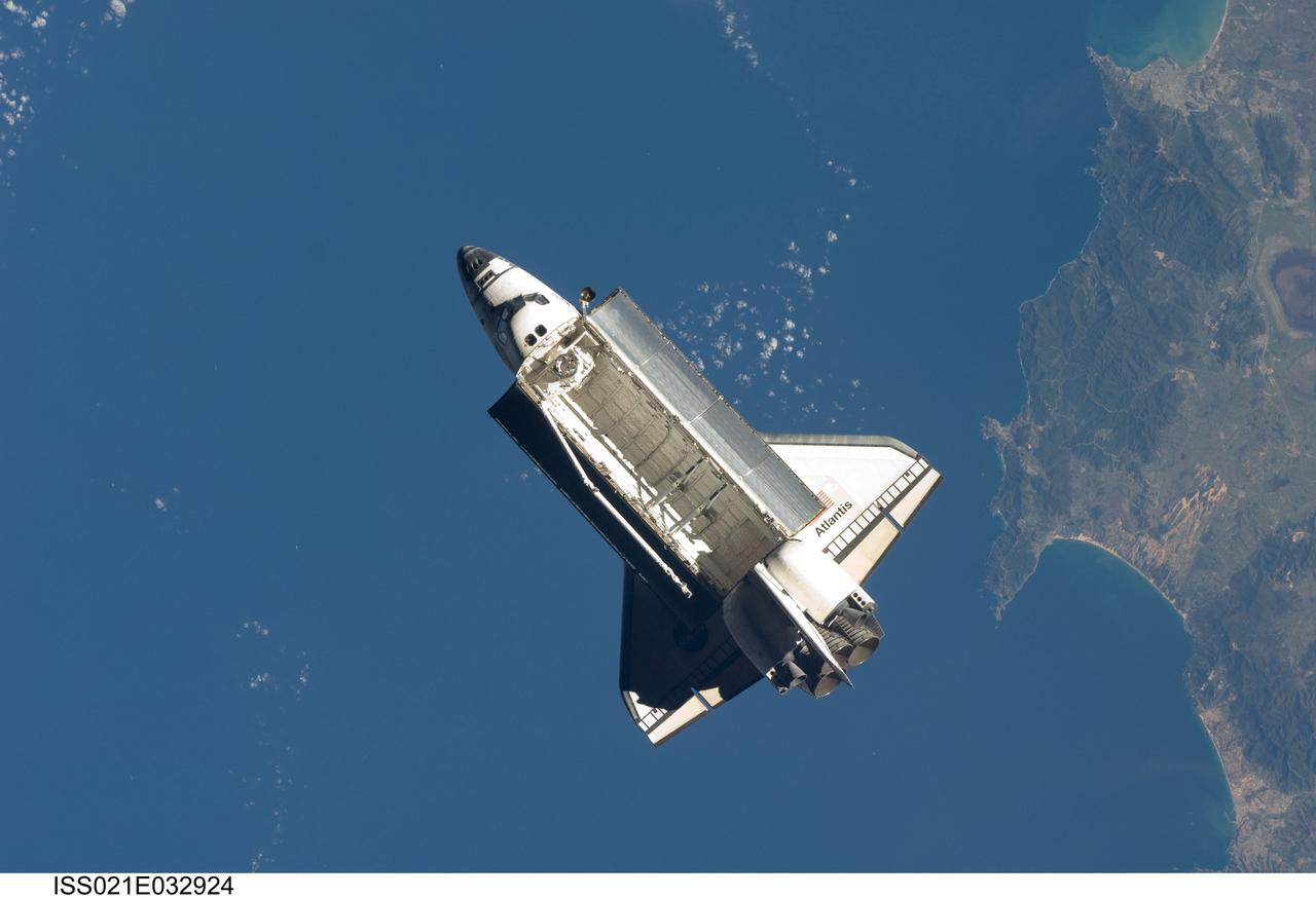 ISS021-E-032924 (25 Nov. 2009) --- Seen over the Mediterranean Sea, near the Algerian coast, the space shuttle Atlantis (STS-129) is featured in this image photographed by an Expedition 21 crew member on the International Space Station soon after the shuttle and station began their post-undocking relative separation. Undocking of the two spacecraft occurred at 3:53 a.m. (CST) on Nov. 25, 2009.