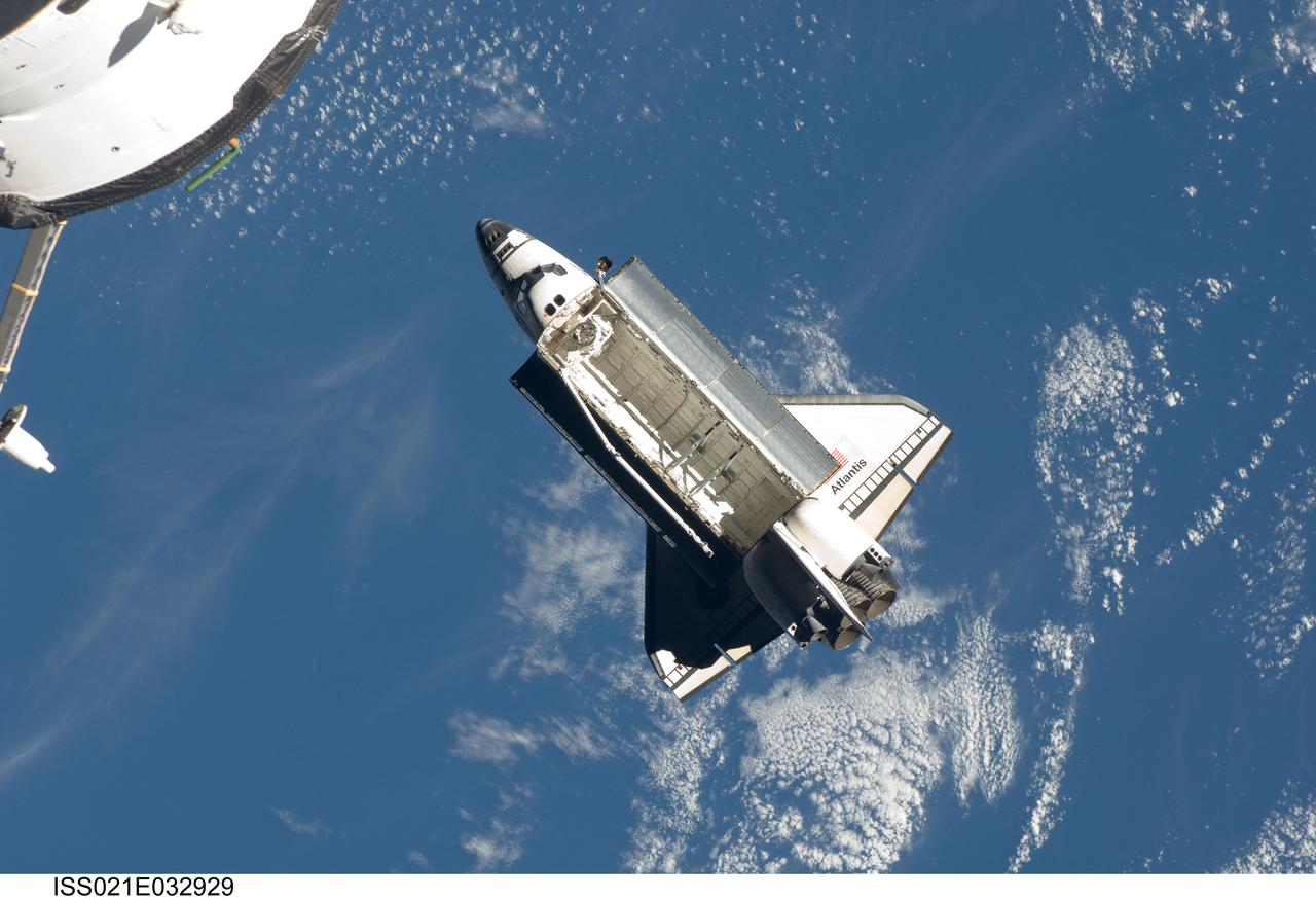 ISS021-E-032929 (25 Nov. 2009) --- Backdropped by a blue and white part of Earth, space shuttle Atlantis (STS-129) is featured in this image photographed by an Expedition 21 crew member on the International Space Station soon after the shuttle and station began their post-undocking relative separation. Undocking of the two spacecraft occurred at 3:53 a.m. (CST) on Nov. 25, 2009.
