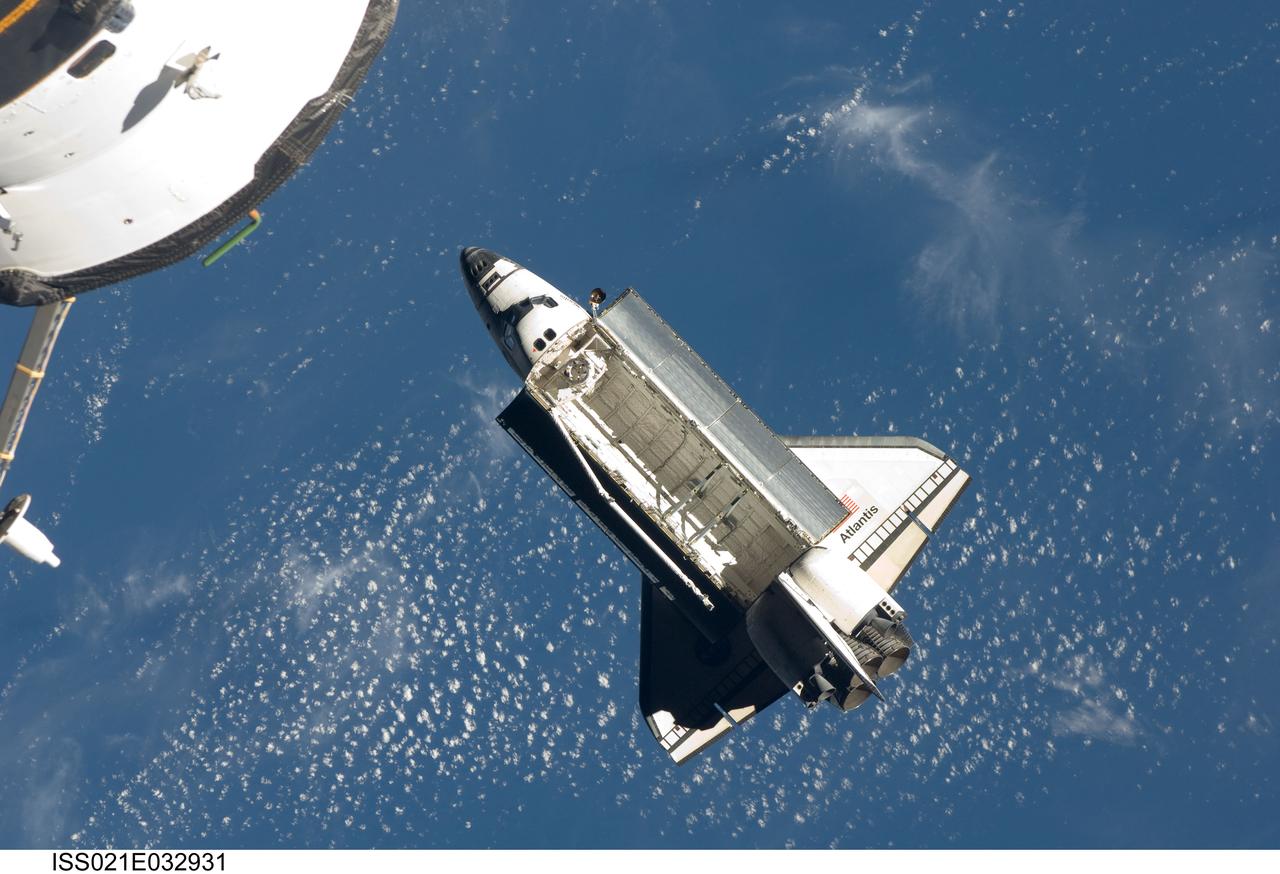 ISS021-E-032931 (25 Nov. 2009) --- Backdropped by a blue and white part of Earth, space shuttle Atlantis (STS-129) is featured in this image photographed by an Expedition 21 crew member on the International Space Station soon after the shuttle and station began their post-undocking relative separation. Undocking of the two spacecraft occurred at 3:53 a.m. (CST) on Nov. 25, 2009.