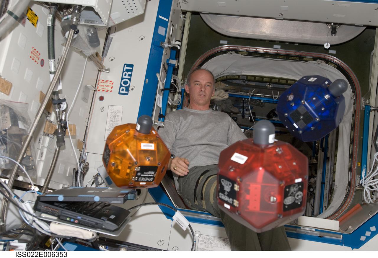ISS022-E-006353 (5 Dec. 2009) --- NASA astronaut Jeffrey Williams, Expedition 22 commander, performs a check of the Synchronized Position Hold, Engage, Reorient, Experimental Satellites (SPHERES) Beacon / Beacon Tester in the Destiny laboratory of the International Space Station.