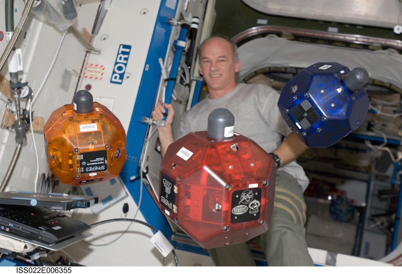 ISS022-E-006355 (5 Dec. 2009) --- NASA astronaut Jeffrey Williams, Expedition 22 commander, performs a check of the Synchronized Position Hold, Engage, Reorient, Experimental Satellites (SPHERES) Beacon / Beacon Tester in the Destiny laboratory of the International Space Station.