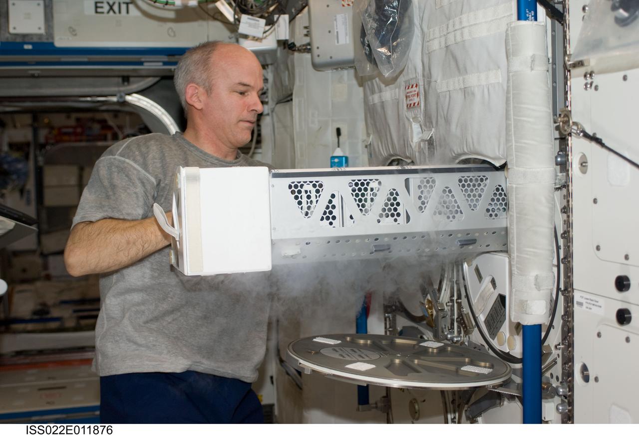 ISS022-E-011876 (16 Dec. 2009) --- NASA astronaut Jeffrey Williams, Expedition 22 commander, services the Advanced Plant Experiments on Orbit-Cambium (APEX-C) payload in the Minus Eighty Laboratory Freezer for ISS-2 (MELFI-2) in the Destiny laboratory of the International Space Station.