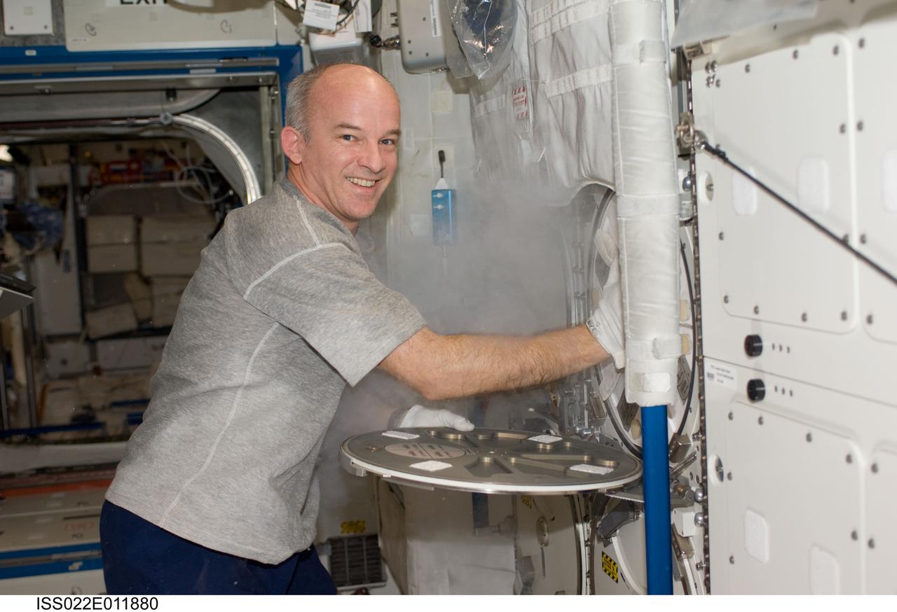 ISS022-E-011880 (16 Dec. 2009) --- NASA astronaut Jeffrey Williams, Expedition 22 commander, services the Advanced Plant Experiments on Orbit-Cambium (APEX-C) payload in the Minus Eighty Laboratory Freezer for ISS-2 (MELFI-2) in the Destiny laboratory of the International Space Station.