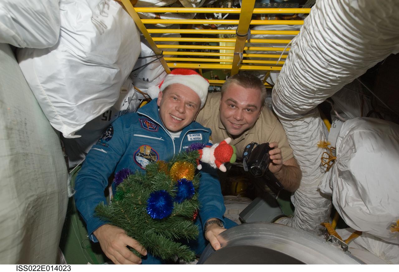ISS022-E-014023 (22 Dec. 2009) --- Russian cosmonauts Oleg Kotov (left) and Maxim Suraev, both Expedition 22 flight engineers, pose for a photo after Kotov arrived on a Soyuz TMA-17 spacecraft with NASA astronaut T.J. Creamer (out of frame) and Japan Aerospace Exploration Agency astronaut Soichi Noguchi (out of frame), both flight engineers. The crew members launched from the Baikonur Cosmodrome in Kazakhstan 3:52 p.m. (CST) on Dec. 20, 2009, and docked to the station at 4:48 p.m. on Dec. 22.
