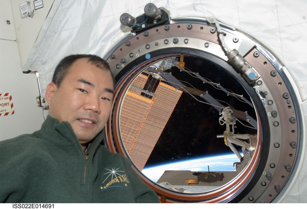 ISS022-E-014691 (25 Dec. 2009) --- Japan Aerospace Exploration Agency astronaut Soichi Noguchi, Expedition 22 flight engineer, takes a break from housekeeping chores to pose for a photo near a window in the Kibo laboratory of the International Space Station.