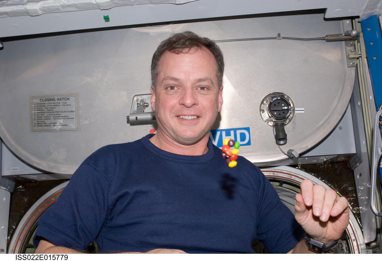 ISS022-E-015779 (25 Dec. 2009) --- NASA astronaut T.J. Creamer, Expedition 22 flight engineer, is pictured near candy floating freely in the Harmony node of the International Space Station.