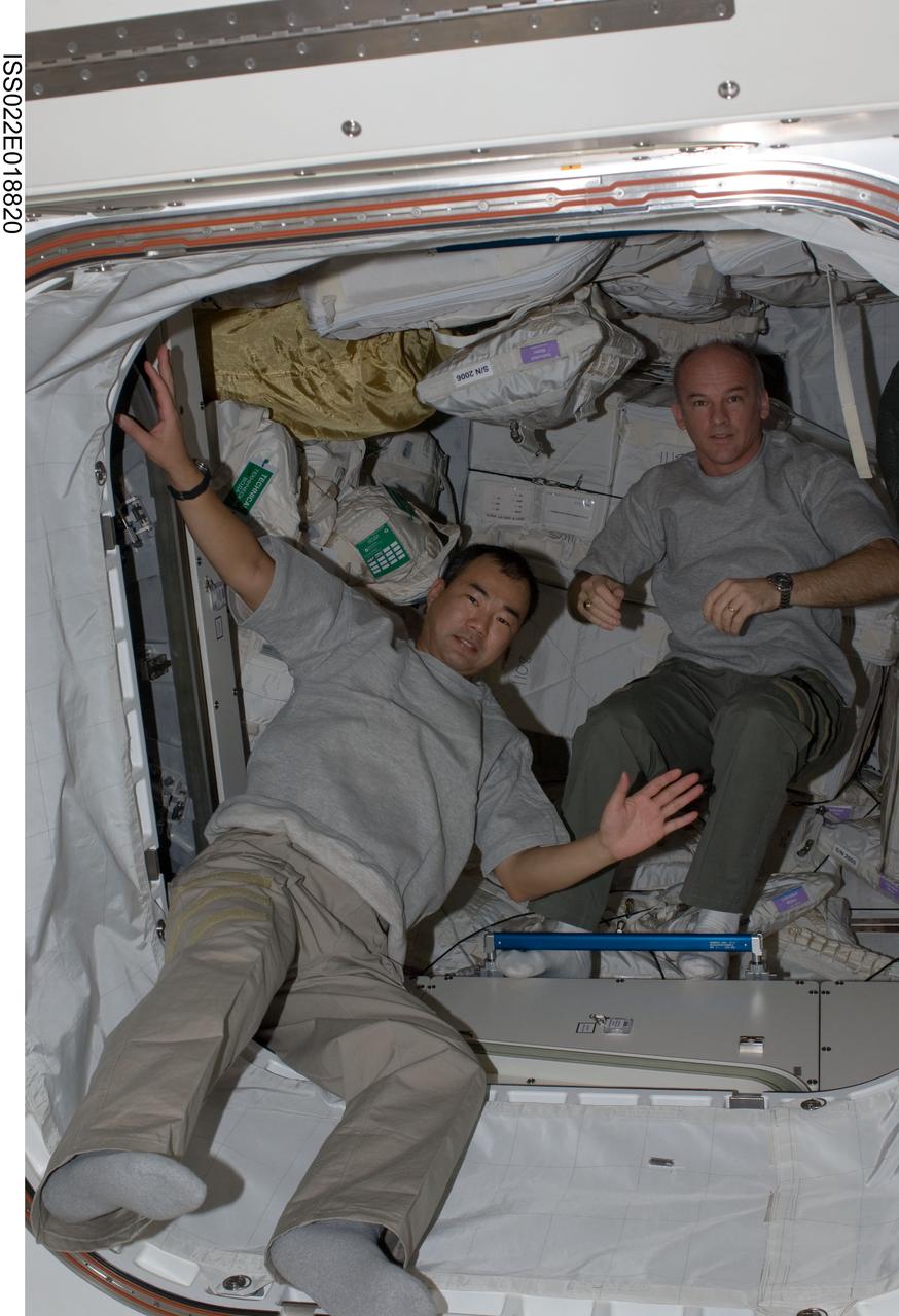 ISS022-E-018820 (3 Jan. 2010) --- NASA astronaut Jeffrey Williams (right), Expedition 22 commander; and Japan Aerospace Exploration Agency astronaut Soichi Noguchi, flight engineer, are pictured in a hatch on the International Space Station.