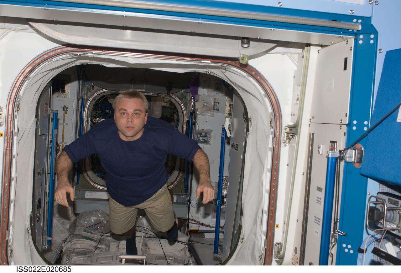 ISS022-E-020685 (5 Jan. 2010) --- Russian cosmonaut Maxim Suraev, Expedition 22 flight engineer, floats from the Harmony node into the Kibo laboratory of the International Space Station.