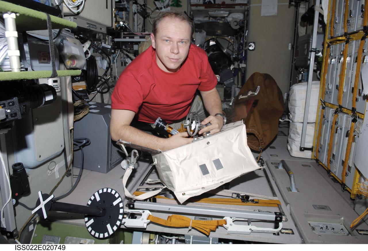 ISS022-E-020749 (6 Jan. 2010) --- Russian cosmonaut Oleg Kotov, Expedition 22 flight engineer, works with extravehicular activity (EVA) equipment in the Zvezda Service Module of the International Space Station.
