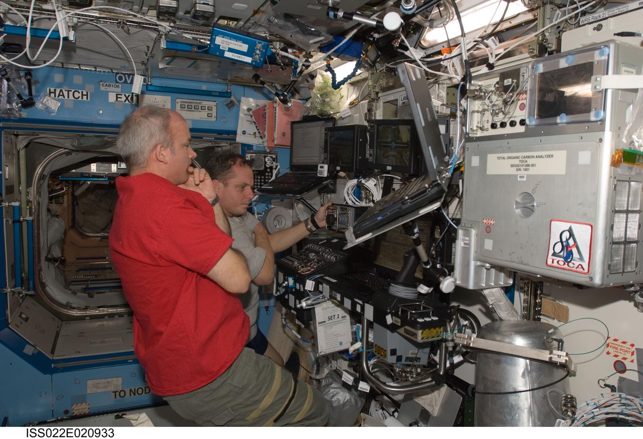 ISS022-E-020933 (8 Jan. 2010) --- NASA astronauts Jeffrey Williams (foreground), Expedition 22 commander; and T.J. Creamer, flight engineer, work the controls of the Space Station Remote Manipulator System (SSRMS) in the Destiny laboratory of the International Space Station during a checkout/training run on the SSRMS for the upcoming External Storage Platform 3 (ESP-3) relocation.