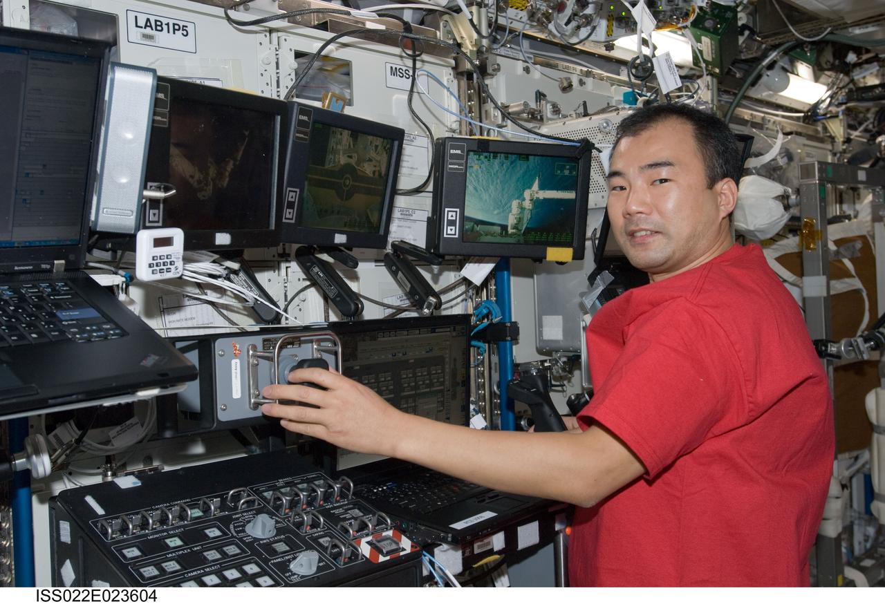 ISS022-E-023604 (12 Jan. 2010) --- Japan Aerospace Exploration Agency (JAXA) astronaut Soichi Noguchi, Expedition 22 flight engineer, works controls at the Canadarm2 workstation in the Destiny laboratory of the International Space Station during the relocation of the External Stowage Platform 3 (ESP-3) from the P3 truss upper site to the S3 truss lower site.