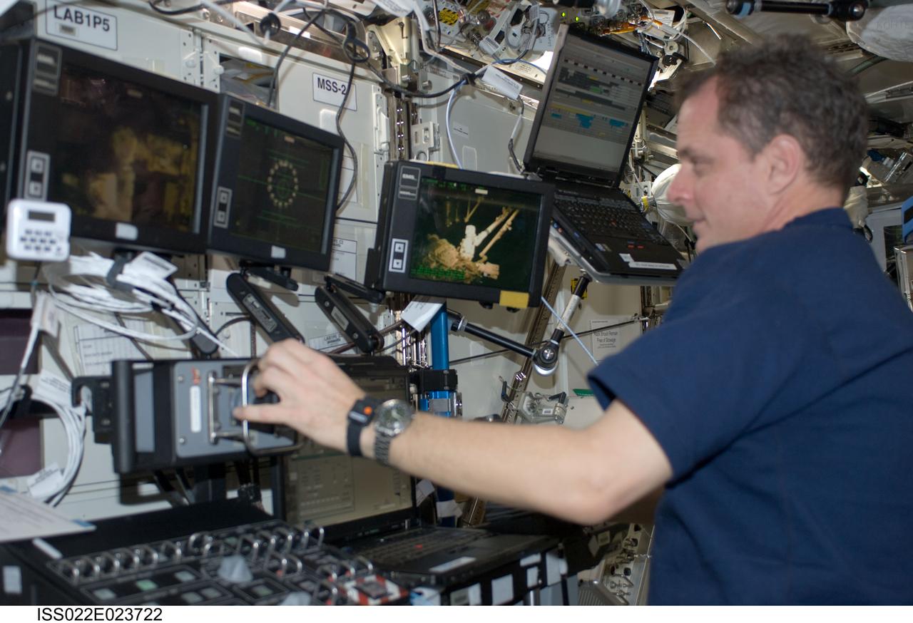ISS022-E-023722 (11 Jan. 2010) --- NASA astronaut T.J. Creamer, Expedition 22 flight engineer, works controls at the Canadarm2 workstation in the Destiny laboratory of the International Space Station.
