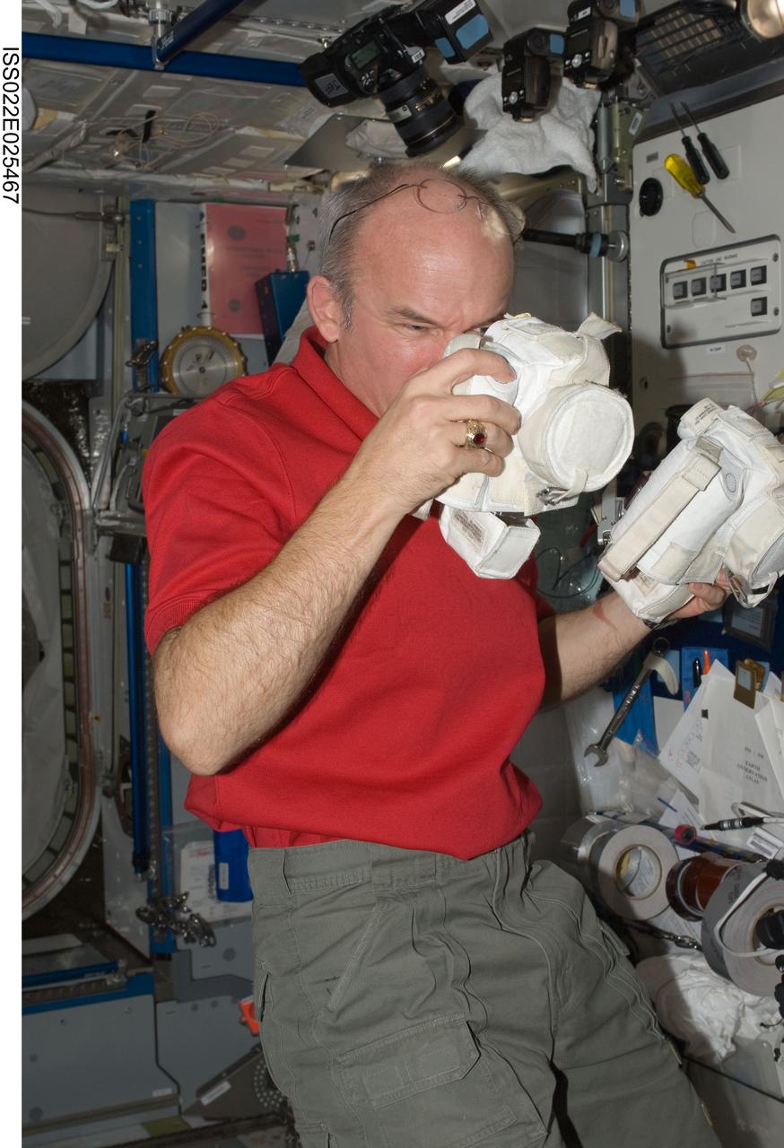 ISS022-E-025467 (13 Jan. 2010) --- NASA astronaut Jeffrey Williams, Expedition 22 commander, holds extravehicular activity (EVA) cameras in the Harmony node of the International Space Station.