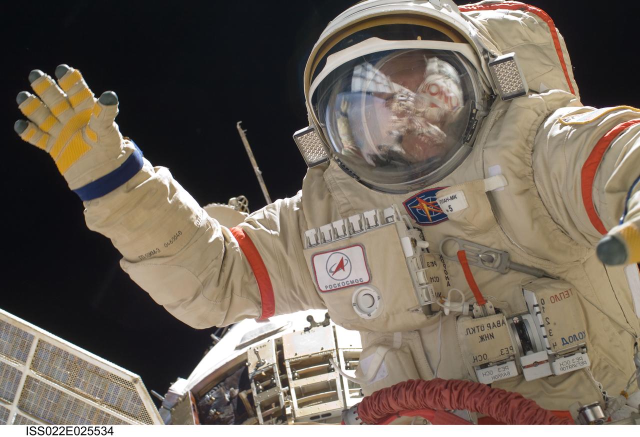 ISS022-E-025534 (14 Jan. 2010) --- Russian cosmonauts Oleg Kotov and Maxim Suraev (out of frame), both Expedition 22 flight engineers, participate in a session of extravehicular activity (EVA) as maintenance and construction continue on the International Space Station. During the spacewalk, Kotov and Suraev prepared the Mini-Research Module 2 (MRM2), known as Poisk, for future Russian vehicle dockings. Suraev and NASA astronaut Jeffrey Williams, commander, will be the first to use the new docking port when they relocate their Soyuz TMA-16 spacecraft from the aft port of the Zvezda Service Module on Jan. 21.