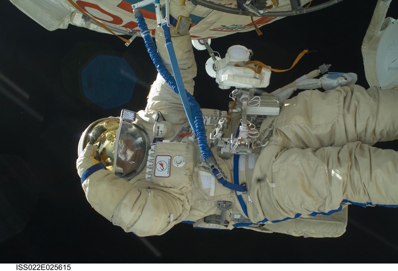 ISS022-E-025615 (14 Jan. 2010) --- Russian cosmonauts Maxim Suraev and Oleg Kotov (out of frame), both Expedition 22 flight engineers, participate in a session of extravehicular activity (EVA) as maintenance and construction continue on the International Space Station. During the spacewalk, Suraev and Kotov prepared the Mini-Research Module 2 (MRM2), known as Poisk, for future Russian vehicle dockings. Suraev and NASA astronaut Jeffrey Williams, commander, will be the first to use the new docking port when they relocate their Soyuz TMA-16 spacecraft from the aft port of the Zvezda Service Module on Jan. 21.