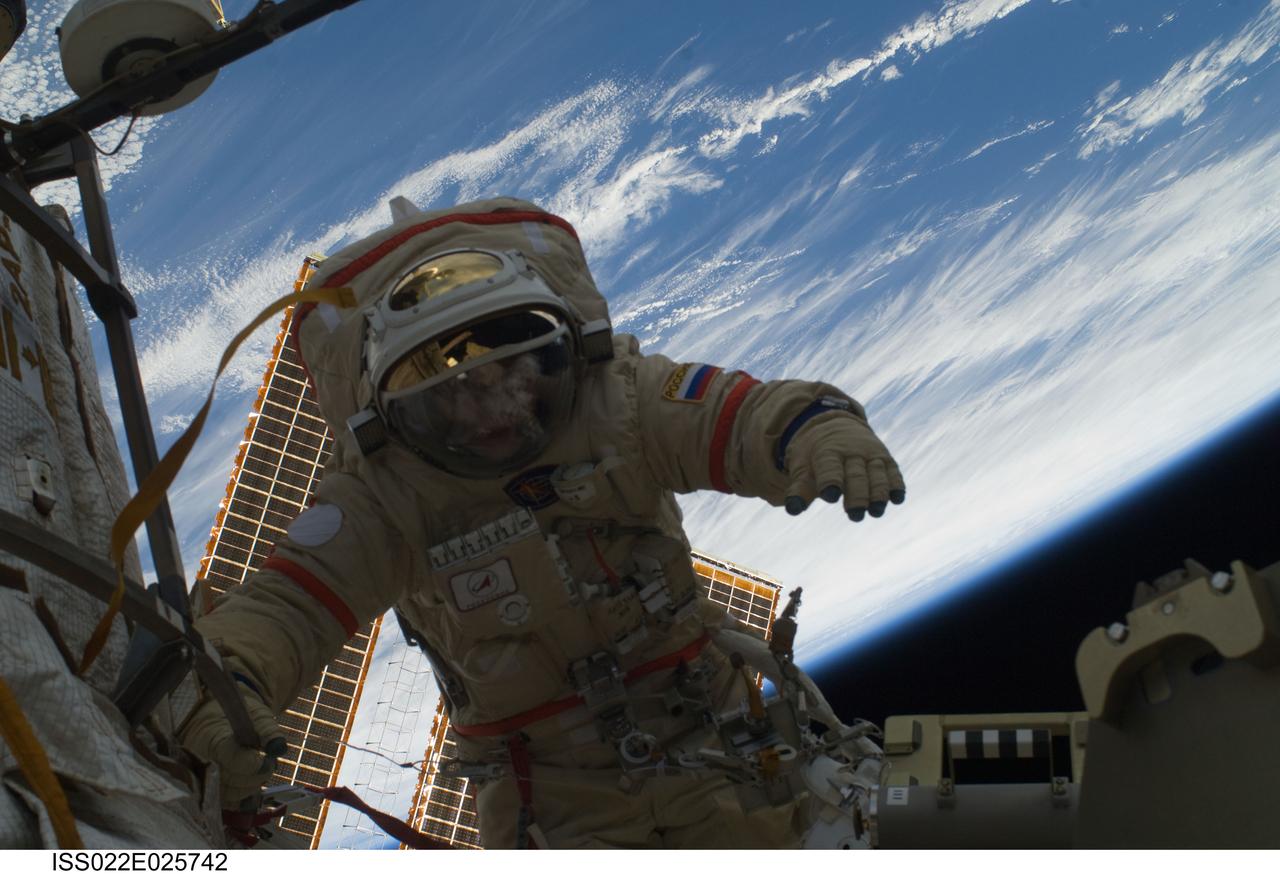 ISS022-E-025742 (14 Jan. 2010) --- Russian cosmonauts Oleg Kotov and Maxim Suraev (out of frame), both Expedition 22 flight engineers, participate in a session of extravehicular activity (EVA) as maintenance and construction continue on the International Space Station. During the spacewalk, Kotov and Suraev prepared the Mini-Research Module 2 (MRM2), known as Poisk, for future Russian vehicle dockings. Suraev and NASA astronaut Jeffrey Williams, commander, will be the first to use the new docking port when they relocate their Soyuz TMA-16 spacecraft from the aft port of the Zvezda Service Module on Jan. 21. Earth’s horizon and the blackness of space provide the backdrop for the scene.