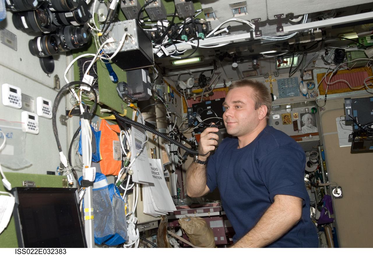 ISS022-E-032383 (16 Jan. 2010) --- Russian cosmonaut Maxim Suraev, Expedition 22 flight engineer, conducts a ham radio session in the Zvezda Service Module of the International Space Station with students, alumni and faculty of Kursk State Technical University.