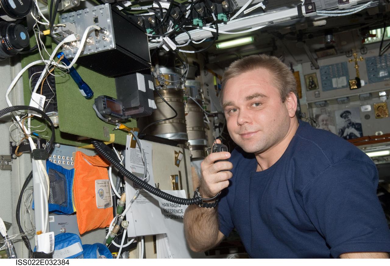 ISS022-E-032384 (16 Jan. 2010) --- Russian cosmonaut Maxim Suraev, Expedition 22 flight engineer, conducts a ham radio session in the Zvezda Service Module of the International Space Station with students, alumni and faculty of Kursk State Technical University.