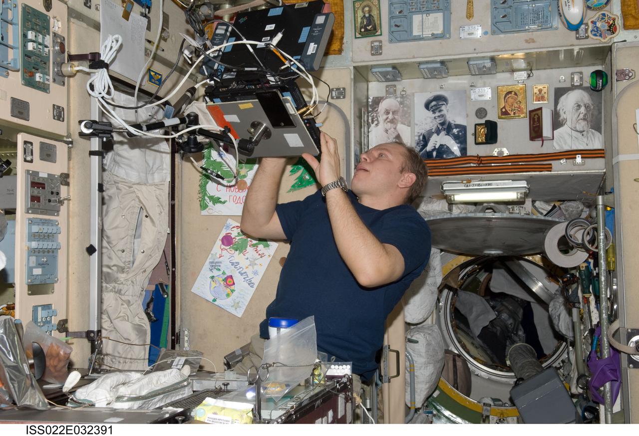 ISS022-E-032391 (18 Jan. 2010) --- Russian cosmonaut Oleg Kotov, Expedition 22 flight engineer, uses a computer in the Zvezda Service Module of the International Space Station.