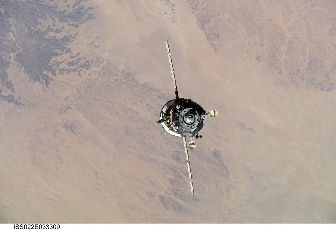 ISS022-E-033309 (21 Jan. 2010) --- The Soyuz TMA-16 spacecraft is featured in this image photographed by an Expedition 22 crew member on the International Space Station during the relocation of the Soyuz from the Zvezda Service Module’s aft port to the Poisk module. Russian cosmonaut Maxim Suraev, Soyuz commander and Expedition 22 flight engineer; along with NASA astronaut Jeffrey Williams, Expedition 22 commander, undocked the Soyuz spacecraft at 4:03 a.m. (CST) and docked it to Poisk at 4:24 a.m. on Jan. 21, 2010.