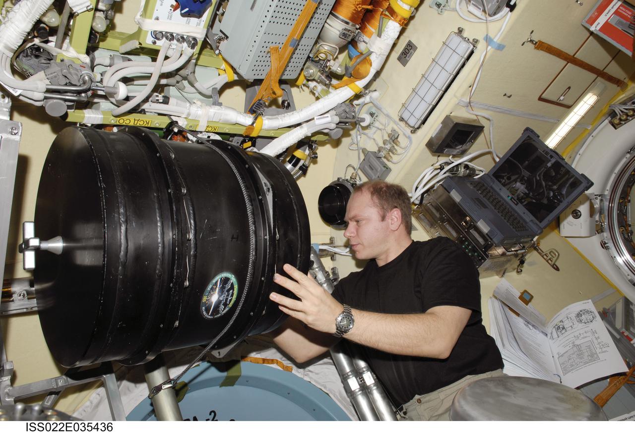 ISS022-E-035436 (25 Jan. 2010) --- Russian cosmonaut Oleg Kotov, Expedition 22 flight engineer, works with the Plasma Crystal-3 experiment in the Zvezda Service Module of the International Space Station.