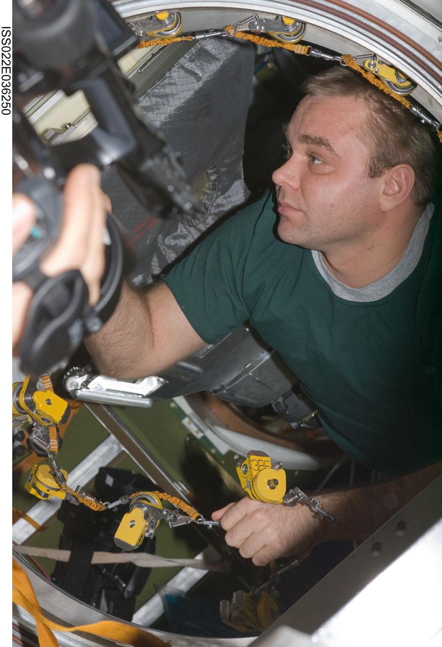 ISS022-E-036250 (21 Jan. 2010) --- Russian cosmonaut Maxim Suraev, Expedition 22 flight engineer, works in the Pirs Docking Compartment of the International Space Station.