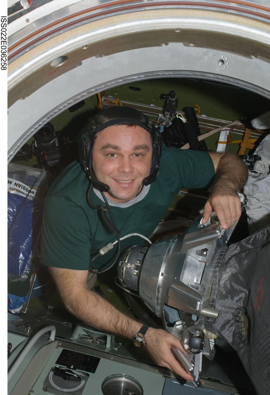 ISS022-E-036258 (21 Jan. 2010) --- Wearing communication headgear, Russian cosmonaut Maxim Suraev, Expedition 22 flight engineer, works in the Pirs Docking Compartment of the International Space Station.